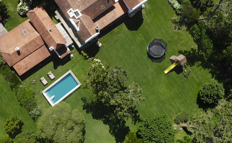 Navimow i110N robot lawn mower mows the large green yard.