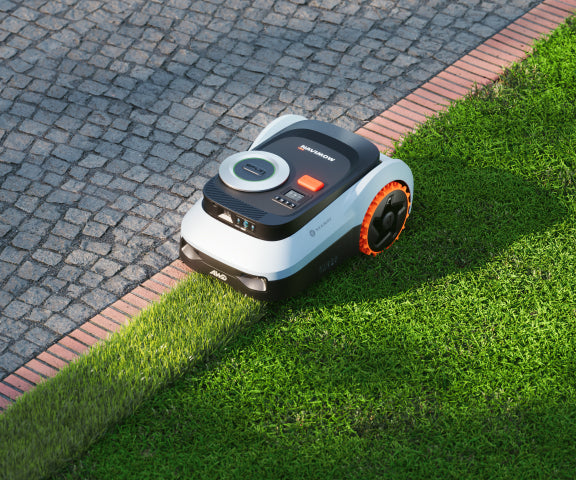Navimow i110E robot lawn mower is on the green grass.