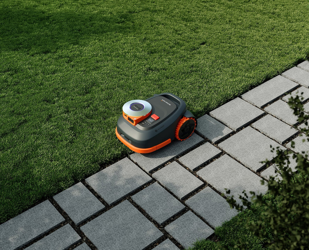 Segway Navimow robot lawn mower on a lush green lawn.