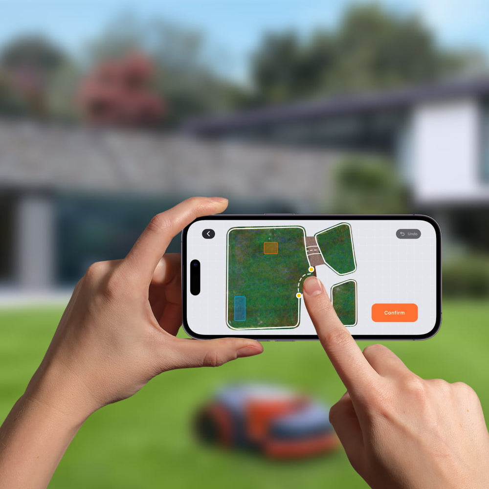 Segway Navimow i105E robot lawn mower is mapping garden zones.