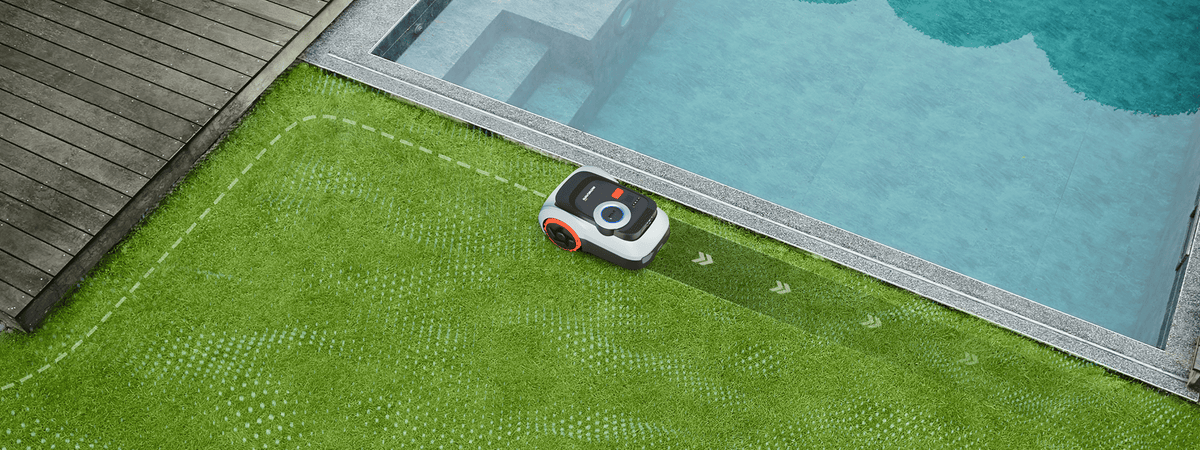 Navimow i Series robot lawn mower mows grass near pool.