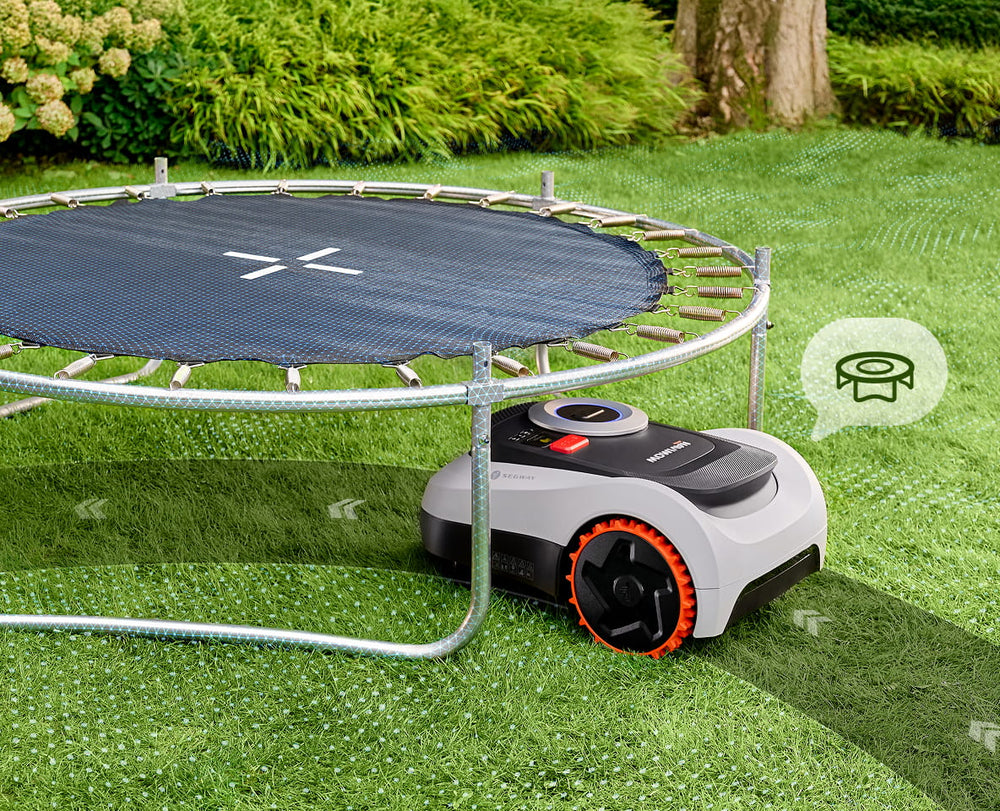 Segway Navimow i110N robot lawn mower mows grass under trampoline.