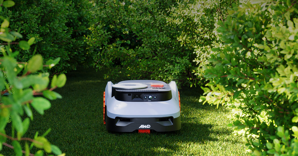Navimow i110E AWD robot lawn mower in a green garden.